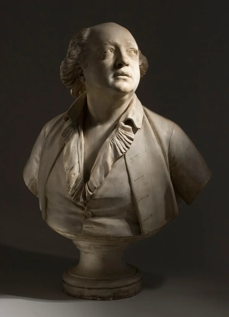 Buste sculpté en marbre représentant un homme du XVIIIᵉ siècle, traditionnellement associé à Cagliostro, éclairage dramatique en clair-obscur.